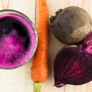 Beet carrots and juice on wood surface