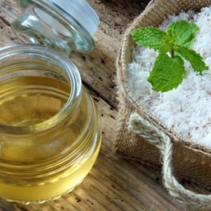 Coconut oil in glass jar with raw coconut