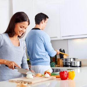 Couple cooking with onions