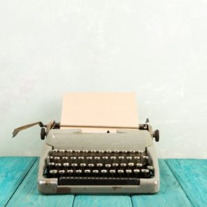 Typewriter on blue table