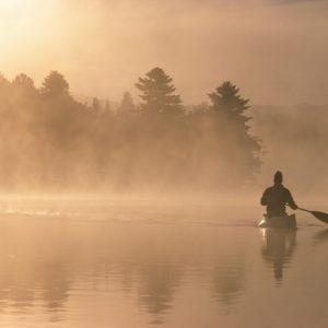 Man canoeing in boat