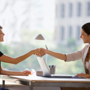 Two businesswomen shaking hands