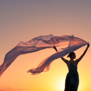 Woman holding silk in wind