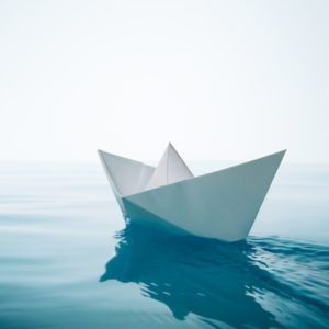 Paper boat floating on water