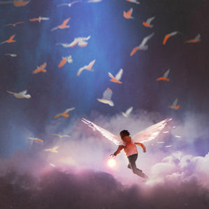 Flying boy in the clouds