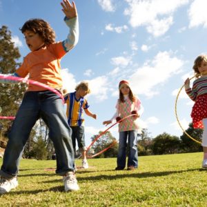 Kids hula hooping in park