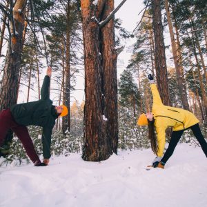 Couple does yoga in the snow