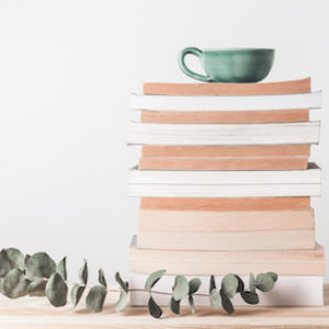 Stack of books and eucalyptus branch