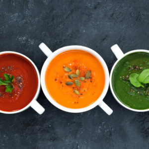 assortment of fresh vegetable soup on a dark background