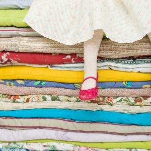 Person with insomnia seeking ways to sleep better, like the Princess and the Pea story.