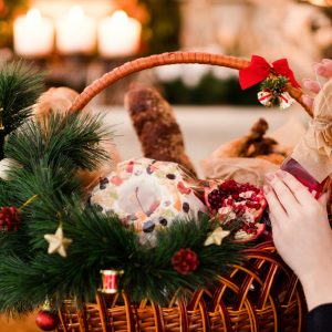 Woman goes for the wine in a holiday gift basket