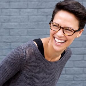 Woman smiling in gray sweater