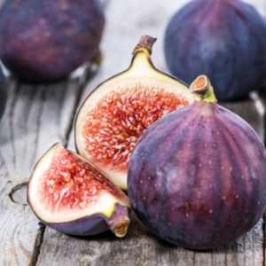 Fresh figs on wood surface