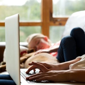 Woman working on her laptop with daughter