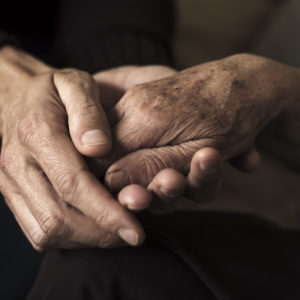 Holding hands with an elderly parent