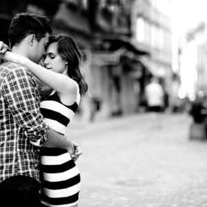 Young couple embracing on street