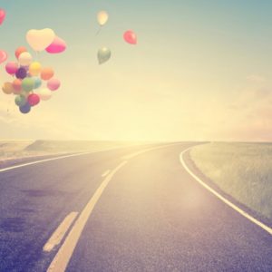 Heart-shaped balloons and open road
