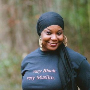 Kameelah Rashad wearing a shirt that says "Very Black, Very Muslim"