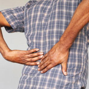 A man grabs his painful back