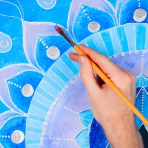 Painting a blue mandala design