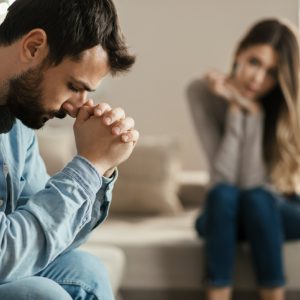 Overwhelmed man with woman not communicating over emotional infidelity