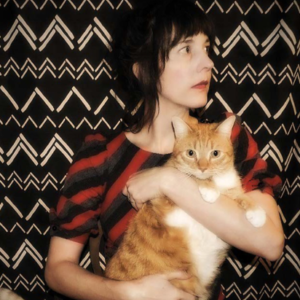 Mary Alayne Thomas holding an orange cat