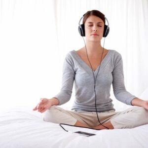 woman listening to music in lotus position