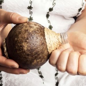 Woman pours coconut oil into hands