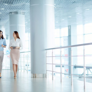 Two women walking while working