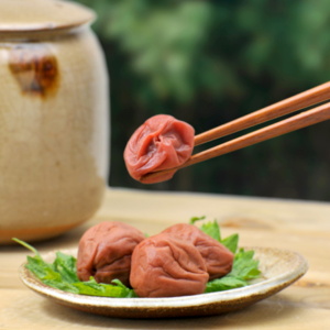 Pickled Plums with chopsticks