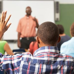 Man raises hand in class