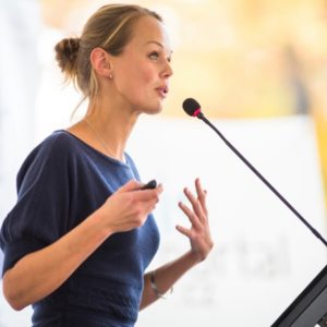 Young woman speaking to crowd