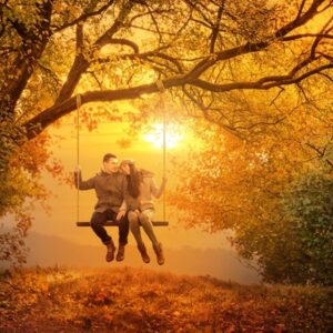 Couple swinging on swing in fall