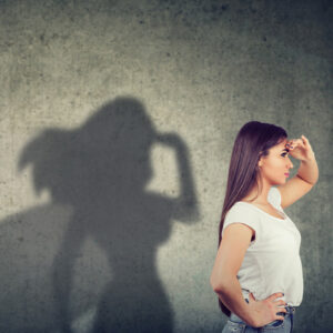 Side view of a woman with superhero shadow