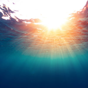 Sun shining through the  surface of the sea