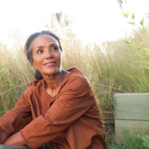 Woman sitting still in a field