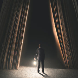 Man holding lantern about to step into mystery book.