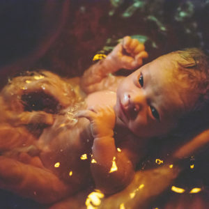Newborn baby in birthing tub