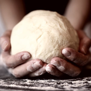 woman holding pizza dough