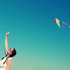 Young woman flying kite