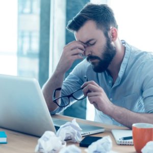 Man frustrated at work considers spiritual meaning of inflammation