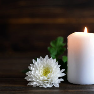 white candle and white flower