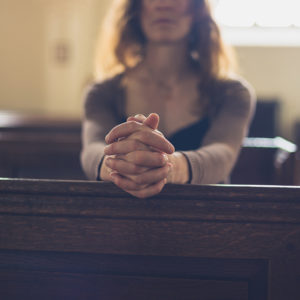 Woman praying in church