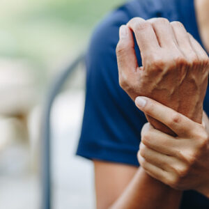 Woman holding sprained wrist can use essential oil inflammation