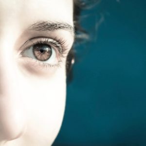 Brown-eyed woman looking toward light