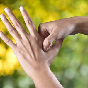 Acupressure being used on hand to treat emotional blocks and restore emotional balance.