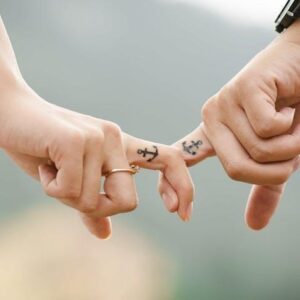 couple holding hands with anchor tattoos show relationship attachment styles