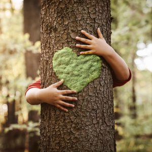 arms hugging tree with heart on it