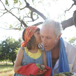 girl whispers in grandpas ear