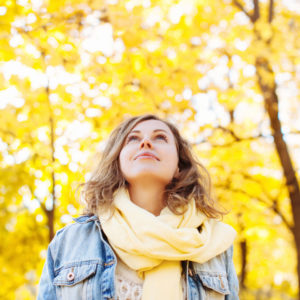 Woman enjoying fall trees